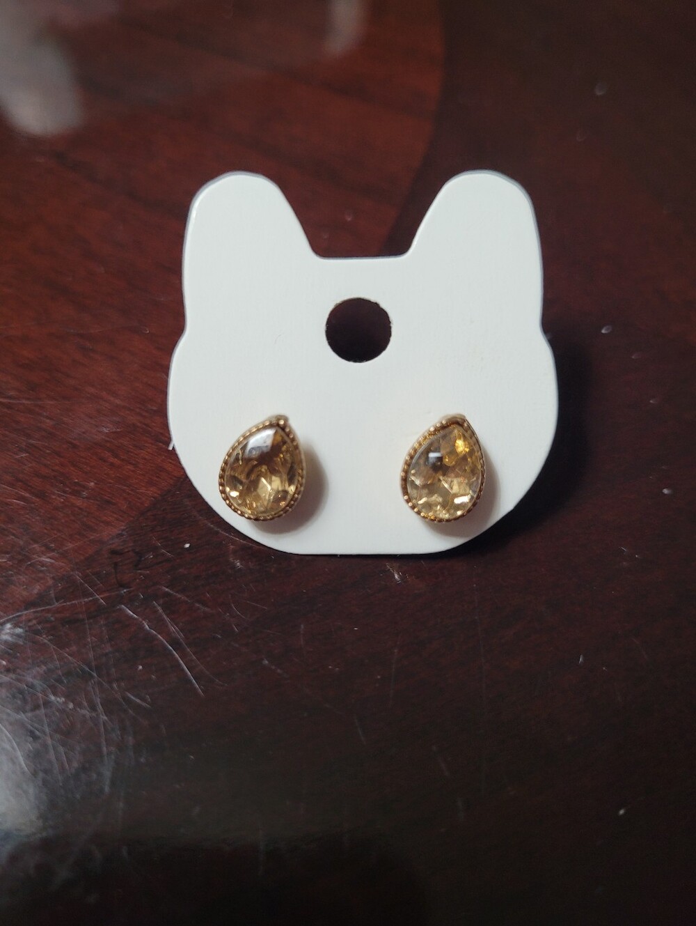 Gold-tone teardrop stud earrings with  yellow rhinestones